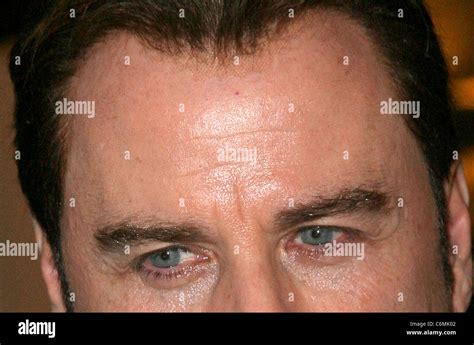 John Travolta seen with a visible mesh hairline while leaving Le Meurice Hotel Paris, France ...