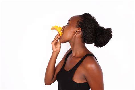 Healthy woman eating sliced mango
