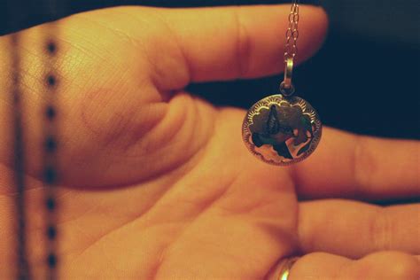 Person Holding Round Silver-colored Necklace Pendant · Free Stock Photo