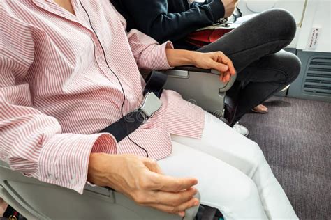 Passenger with Fastened Seat Belt Seated on Aircraft Seat for Safety Stock Image - Image of ...