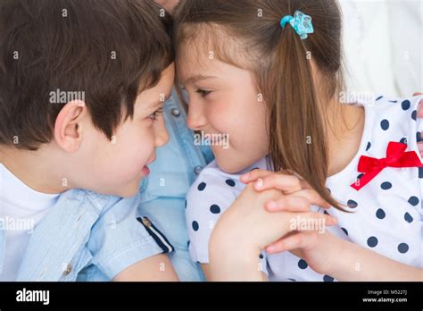 Children competition - boy and girl bumping heads against each other Stock Photo - Alamy