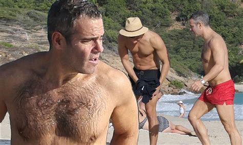 Andy Cohen hits the beach in fire red trunks with hunky boyfriend ...