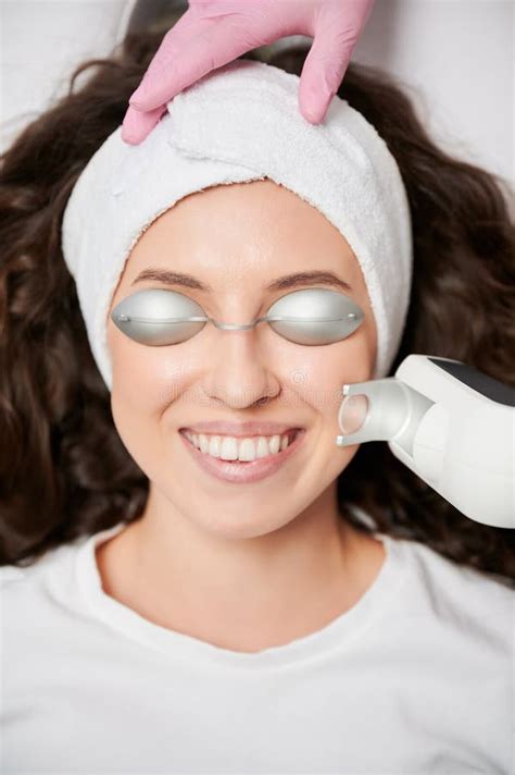 Joyful Woman Receiving Laser Facial Treatment in Beauty Salon. Stock Photo - Image of laser ...