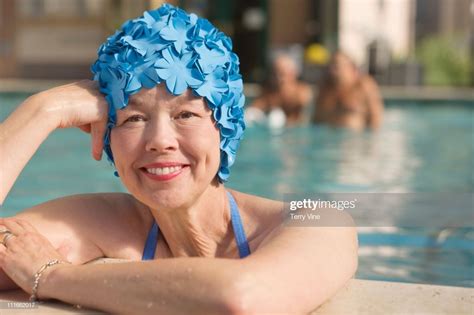 Mixed race woman in swimming pool wearing retro swimming cap | Pool wear, Swim caps, Swimming