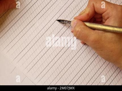 female hand writes with the inky pen the words thanks and calligraphy ...