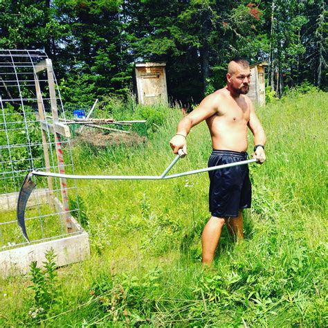 Using A Scythe To Cut The Grass