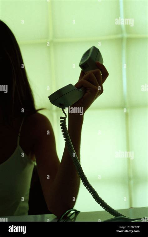 Woman holding landline phone receiver, cropped view Stock Photo - Alamy