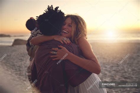 Affectionate couple hugging on sunny sunset summer beach — horizontal, enthusiasm - Stock Photo ...