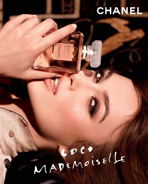 a woman holding a bottle of chanel cout marmeliselle in her hand