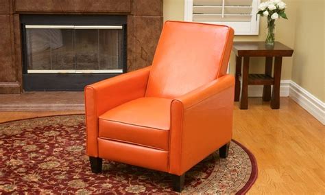 Lean back in this contemporary, bonded-leather recliner so its backrest tilts backward and its ...