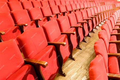 Premium Photo | Row of red seats in a theater with old wooden floor