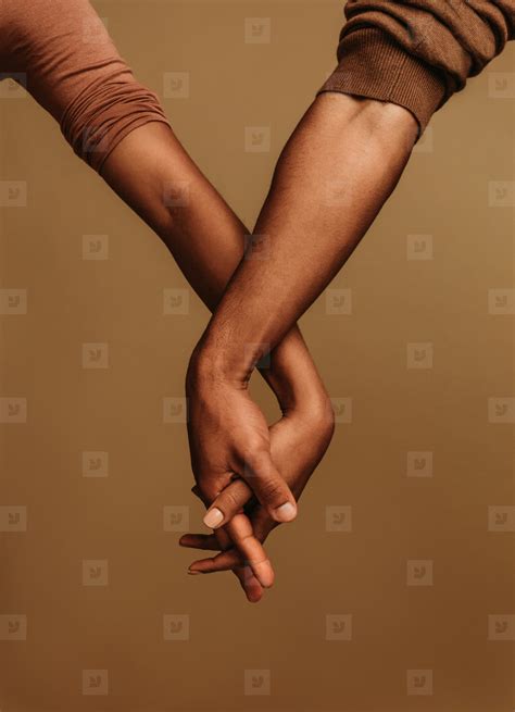 Close up of two hands with fingers interlocked stock photo (216078 ...