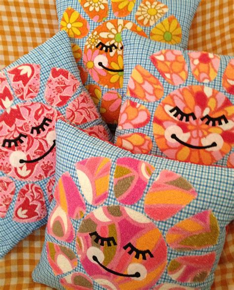 three decorative pillows with faces on them