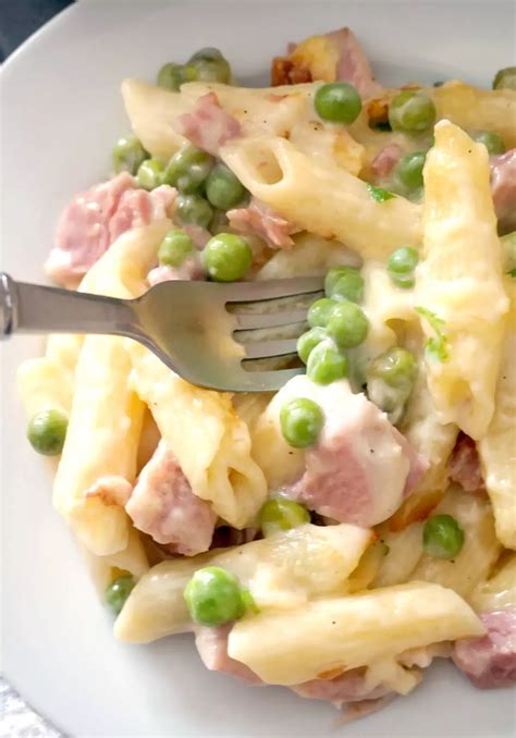ham and pea pasta bake on a white plate with a green border overlay