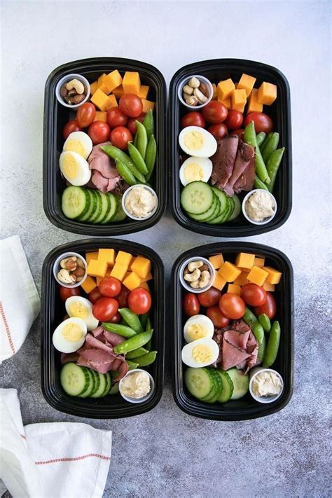 Four prepared high protein snack packs filled with heathy veggies and high protein snacks # ...
