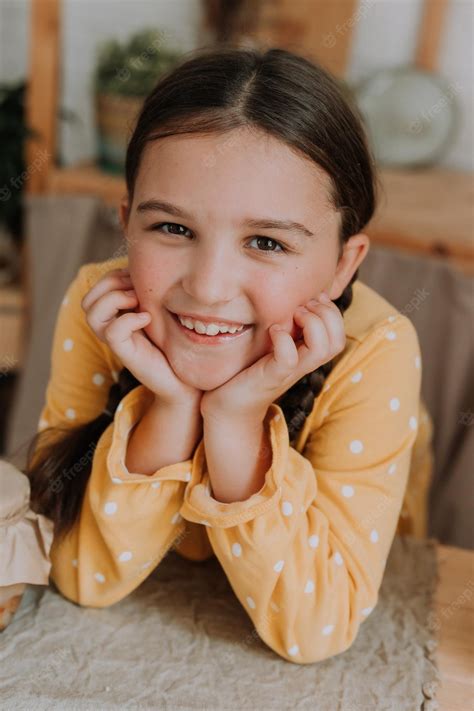 Premium Photo | Little girl in a yellow dress with a wooden spatula in her hands and jam in ...