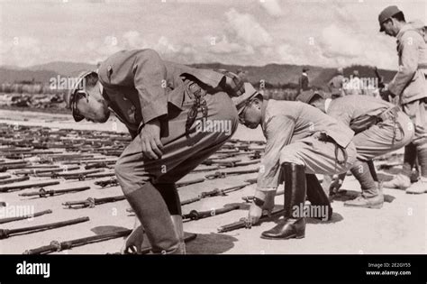 The surrender of Imperial Japan. Japanese soldiers lay down military ...