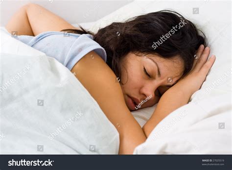 A Young Woman Sleeping In Bed Alone. Stock Photo 27025519 : Shutterstock