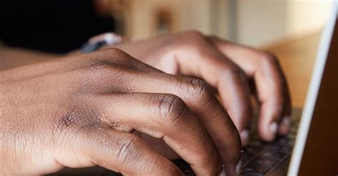 Black man typing on laptop in room · Free Stock Photo