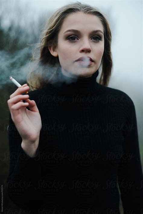 "Portrait Of A Young Woman Smoking" by Stocksy Contributor "Brent Hyll ...