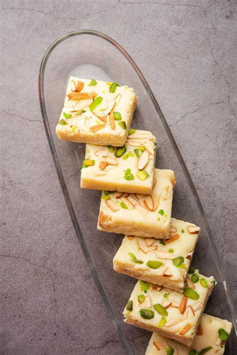 Premium Photo | Milk powder barfi also known as mava burfi white khoya burfi or barfee indian ...