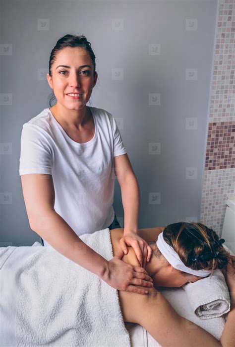 Female Massage Therapist Doing Treatment To Woman In Clinic Photo (197024) - YouWorkForThem