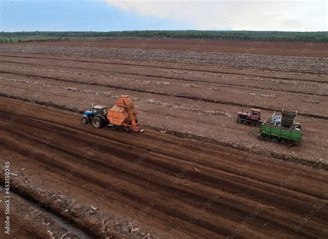 Peat extraction site. Harvester at collecting peat on peatlands. Mining and harvesting peatland ...