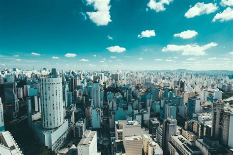 High Angle View of Cityscape Against Cloudy Sky · Free Stock Photo