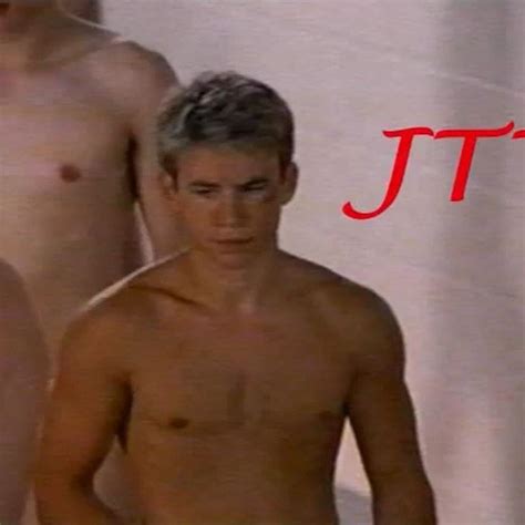 two naked men standing next to each other in front of a white curtain with the word jt on it