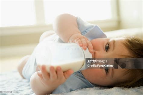 Baby Boy Drinking Milk From Milk Bottle High-Res Stock Photo - Getty Images