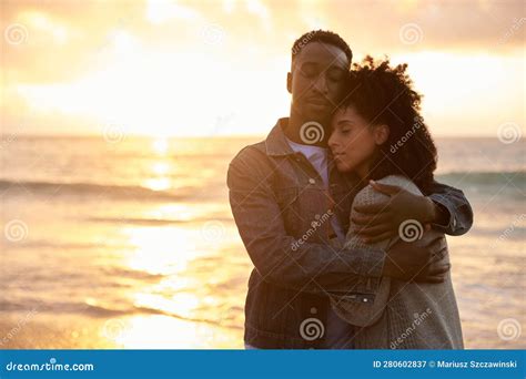 Loving Young Multiethnic Couple Holding Each Other on a Beach at Sunset Stock Image - Image of ...