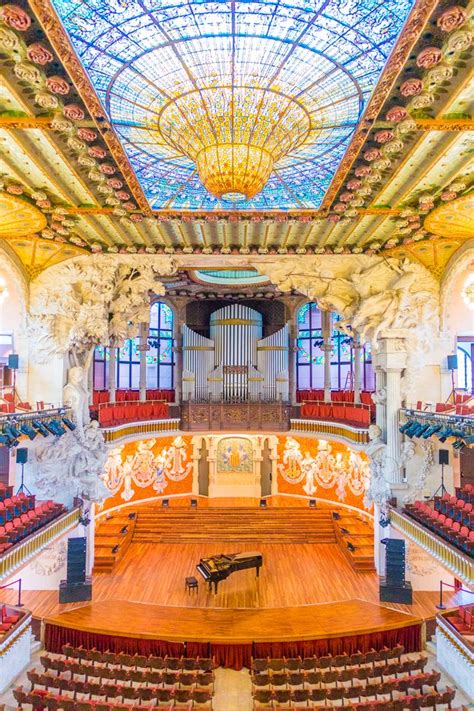 the interior of an ornately decorated auditorium with stained glass ceiling and chandelier