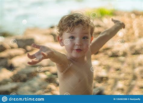 Child Playing Outdoors. Kid we Pour the Sand into the Red Truck. Children Street Games a Boy ...