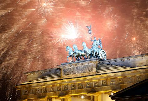 Fireworks explode next to the Quadriga sculpture atop the Brandenburg gate during New Year ...