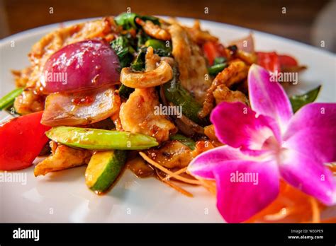 Phat kaphrao Thai basil chicken stir fried with Asian vegetables Stock Photo - Alamy
