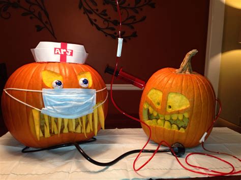 two pumpkins with face masks and wires attached to them