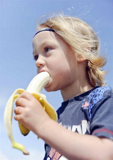 Boy eating banana stock photo