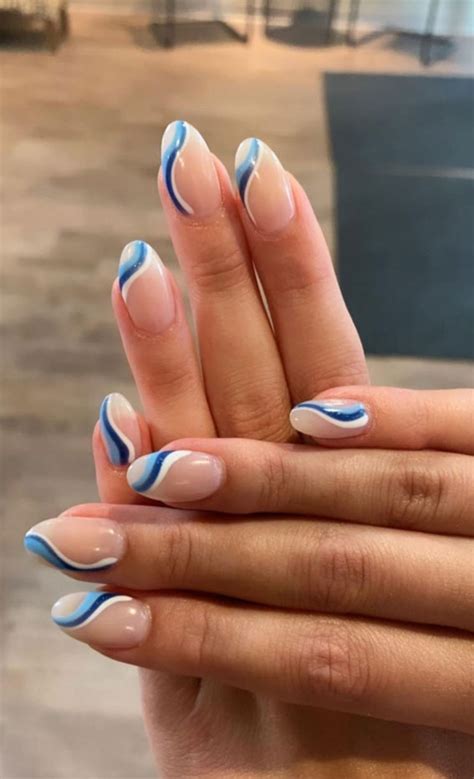 30 Best Spring Nail Ideas For 2022 : Shades of Blue Swirl Nude Base Nails