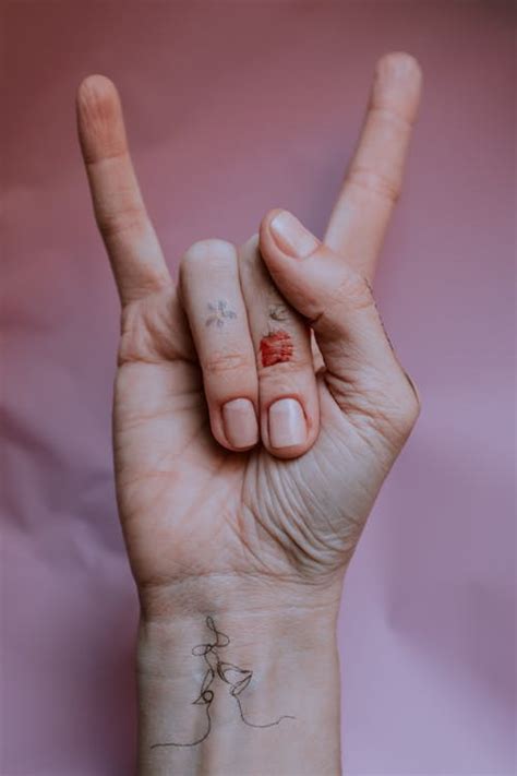 Person's Hand Doing Rock and Roll Hand Sign · Free Stock Photo