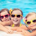 Happy children in the swimming pool Stock Photo by ©Yaruta 69428913