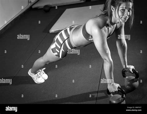 Fitness woman doing kettlebell pushup exercise at gym Stock Photo - Alamy