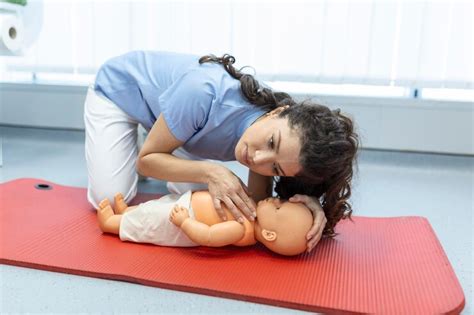 Free Photo | Woman performing cpr on baby training doll with one hand compression first aid ...