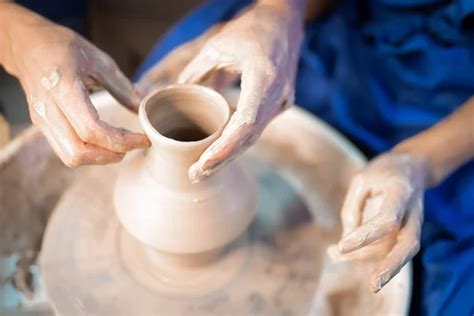 Traditional pottery making, man teacher shows the basics of pottery in art studio. Artist ...