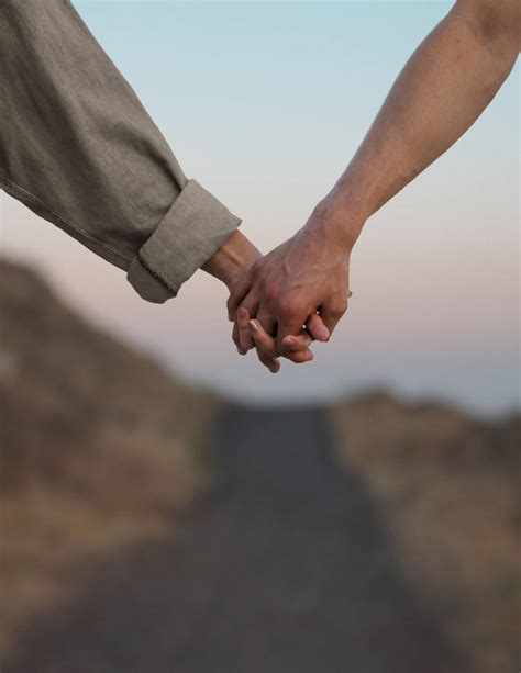 Download Couple In Love Holding Hands Wallpaper | Wallpapers.com