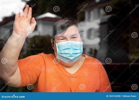 Mentally Disabled Woman with Surgical Mask Waving Out at a Window, Covid-19 Stock Photo - Image ...