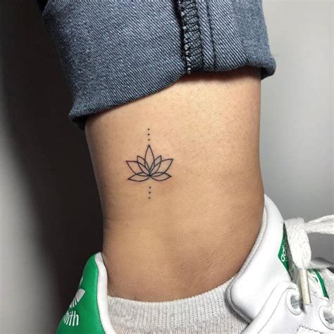 Minimalist lotus flower tattoo on the ankle