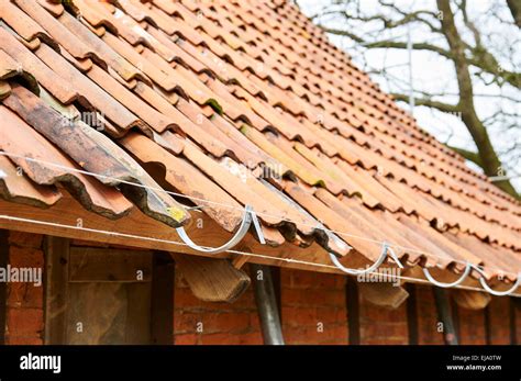 Aligned rain gutter hanger Stock Photo - Alamy