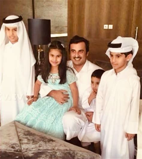 the family is posing for a photo in front of their baby brother's bed