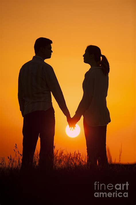 Lovers Holding Hands At Sunset In Silhouette Photograph by Lee Avison ...