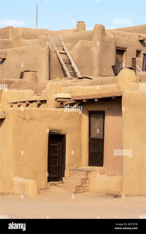 An adobe multistoried house in the Native American adobe village of Taos Pueblo, New Mexico, USA ...